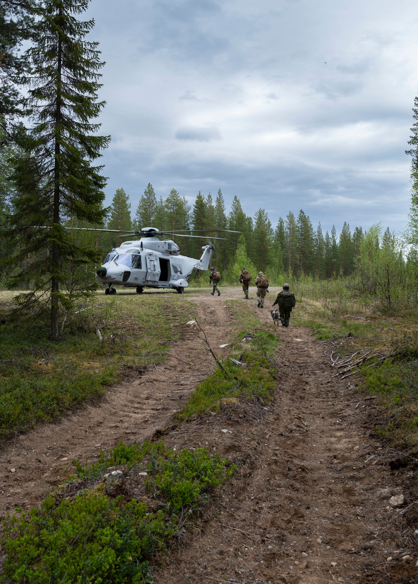 people walking towards helicopter