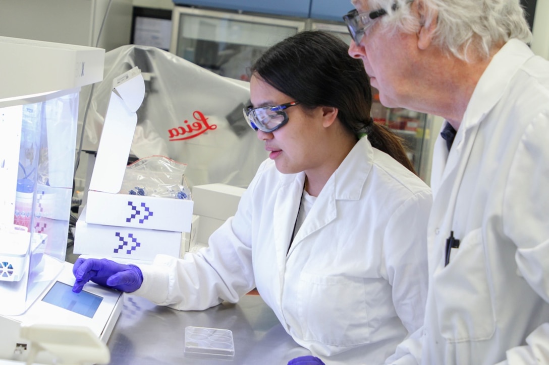 DEVCOM CBC Bioengineering Researcher Priscilla Lee and DEVCOM CBC Senior Biologist Ted Moran use a bioprinter capable of creating synthetic skin at a DEVCOM CBC laboratory at Aberdeen Proving Ground, Maryland.