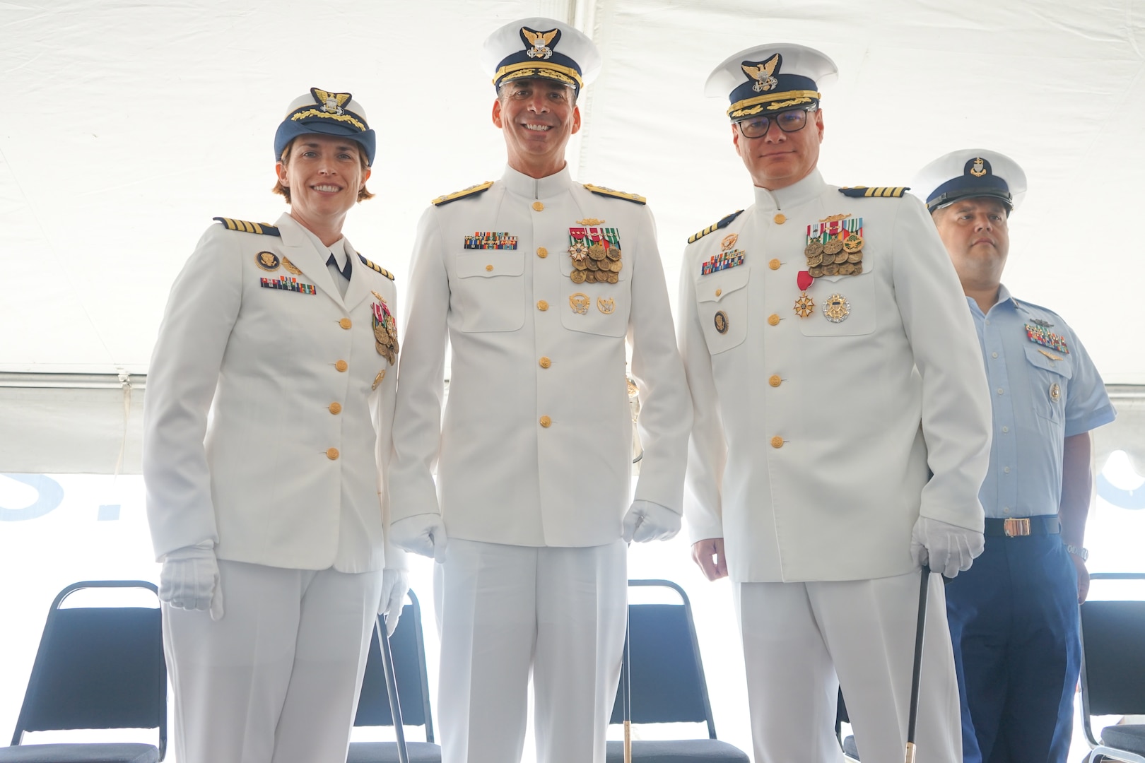Capt. Anne O’Connell, incoming commanding officer of Coast Guard Cutter Stone (WMSL 758), Vice Adm. Nathan Moore, commander, Atlantic Area, and Capt. Jonathan Carter, outgoing commanding officer of Stone, pose for a photo while Senior Chief Petty Officer Emerio Labori, Stone's command senior enlisted leader, looks on during the cutter's change-of-command ceremony in North Charleston, South Carolina, June 5, 2025.  O'Connell is the fourth commanding officer of the 418-foot, Legend-class national security cutter. (U.S. Coast Guard photo  by Ensign Sarah Pearson)