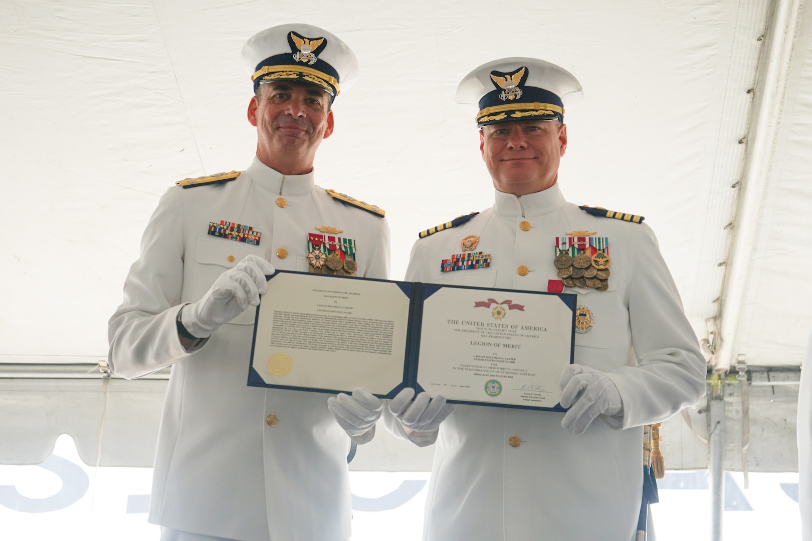 Vice Adm. Nathan Moore, commander, Atlantic Area, and Capt. Jonathan Carter, commanding officer, Coast Guard Cutter Stone (WMSL 758), pose for a photo after Carter was awarded the Legion of Merit during the cutter's change-of-command ceremony in North Charleston, South Carolina, June 5, 2025. The Legion of Merit was presented to Carter for his exceptionally meritorious conduct in the performance of outstanding services while commanding officer of Stone. (U.S. Coast Guard photo by Ensign Sarah Pearson)