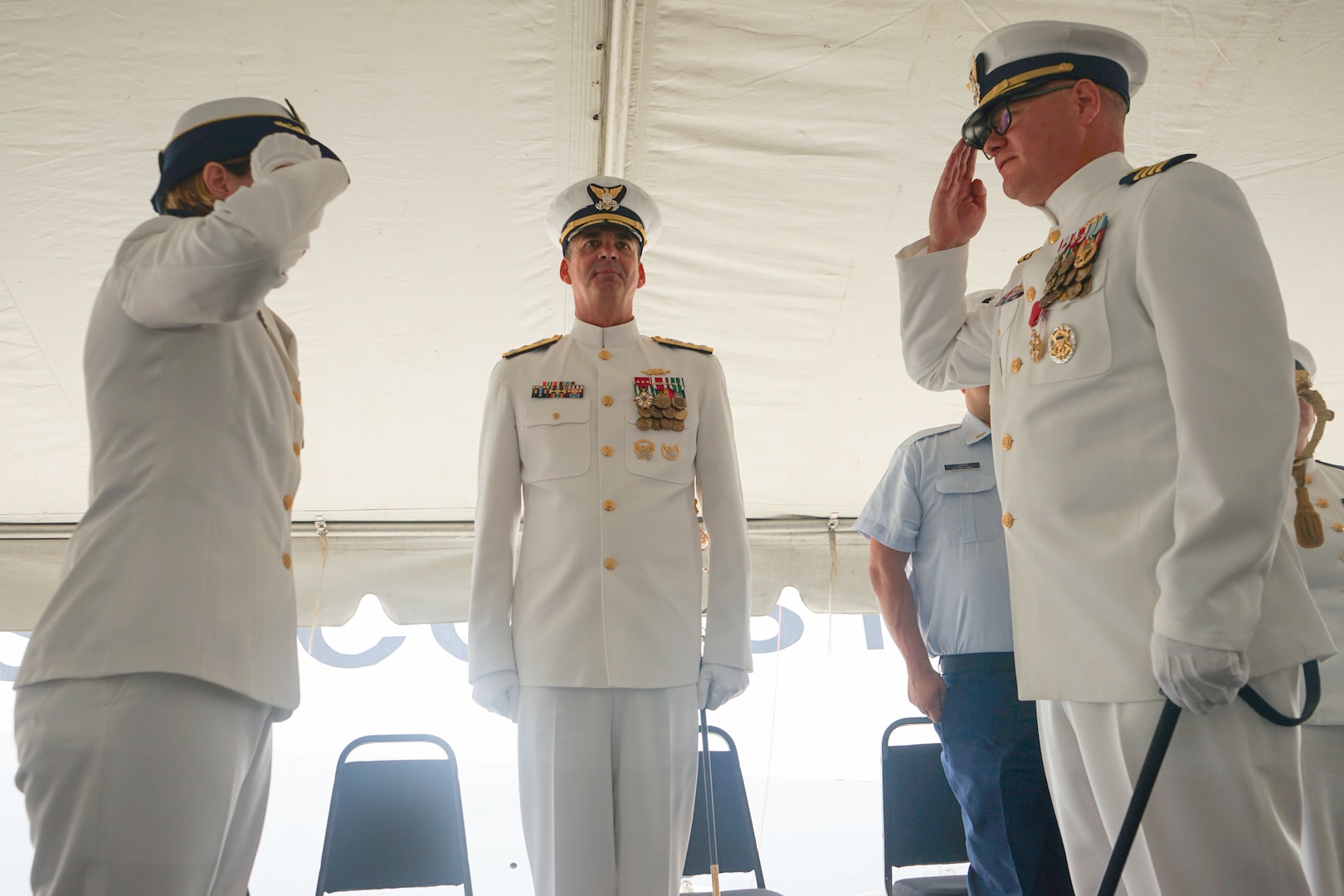 Capt. Anne O’Connell, incoming commanding officer of Coast Guard Cutter Stone (WMSL 758), salutes Capt. Jonathan Carter, outgoing commanding officer of Stone, in front of presiding official Vice Adm. Nathan Moore, commander, Atlantic Area, assembled crew and distinguished guests during the unit's change-of-command ceremony in North Charleston, South Carolina, June 5, 2025. The change-of-command ceremony is a time-honored tradition that formally demonstrates the continuity of authority within a command, conducted before the assembled crew and honored guests. (U.S. Coast Guard photo by Ensign Sarah Pearson)
