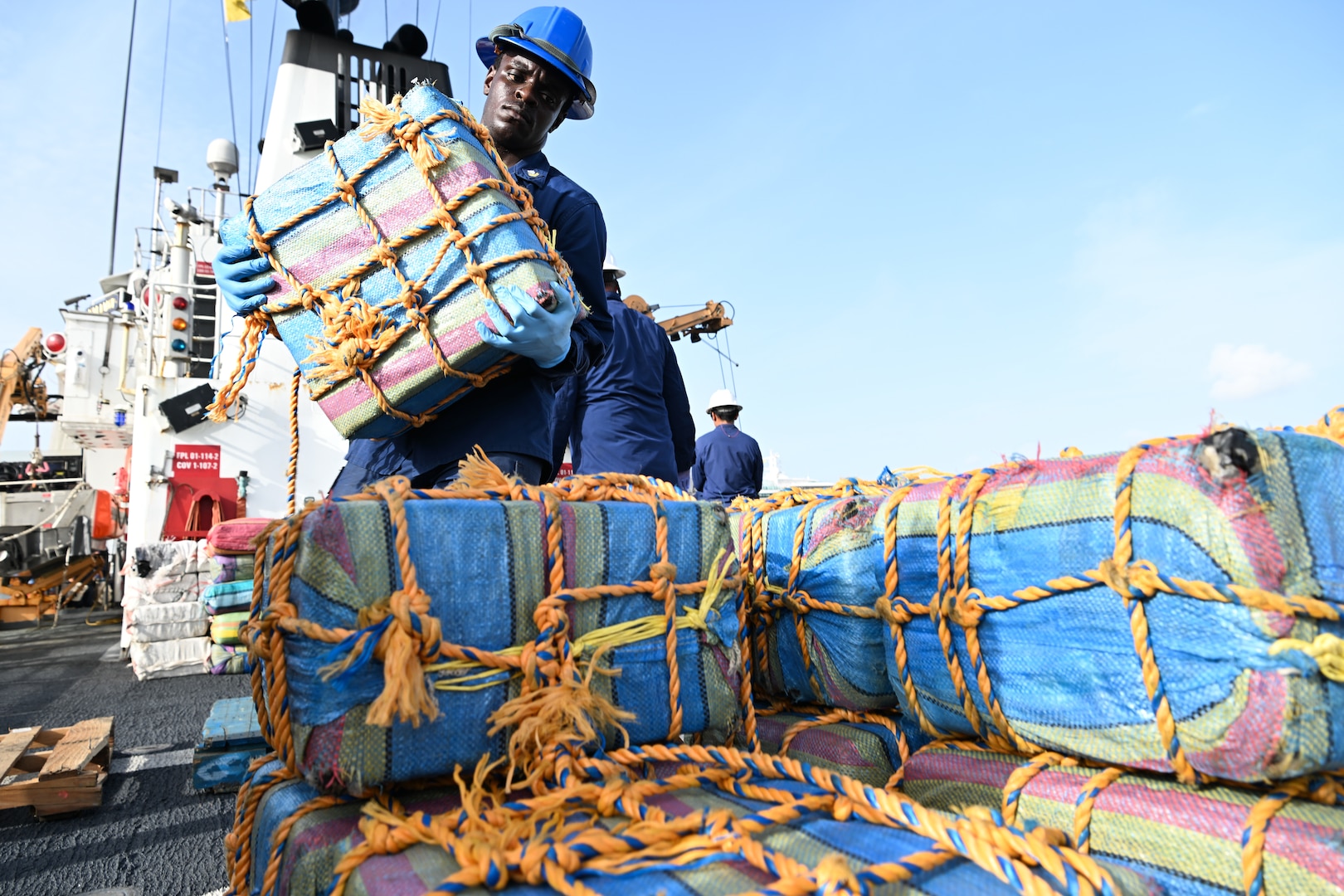 USCGC Valiant crew member loads drugs on pallets