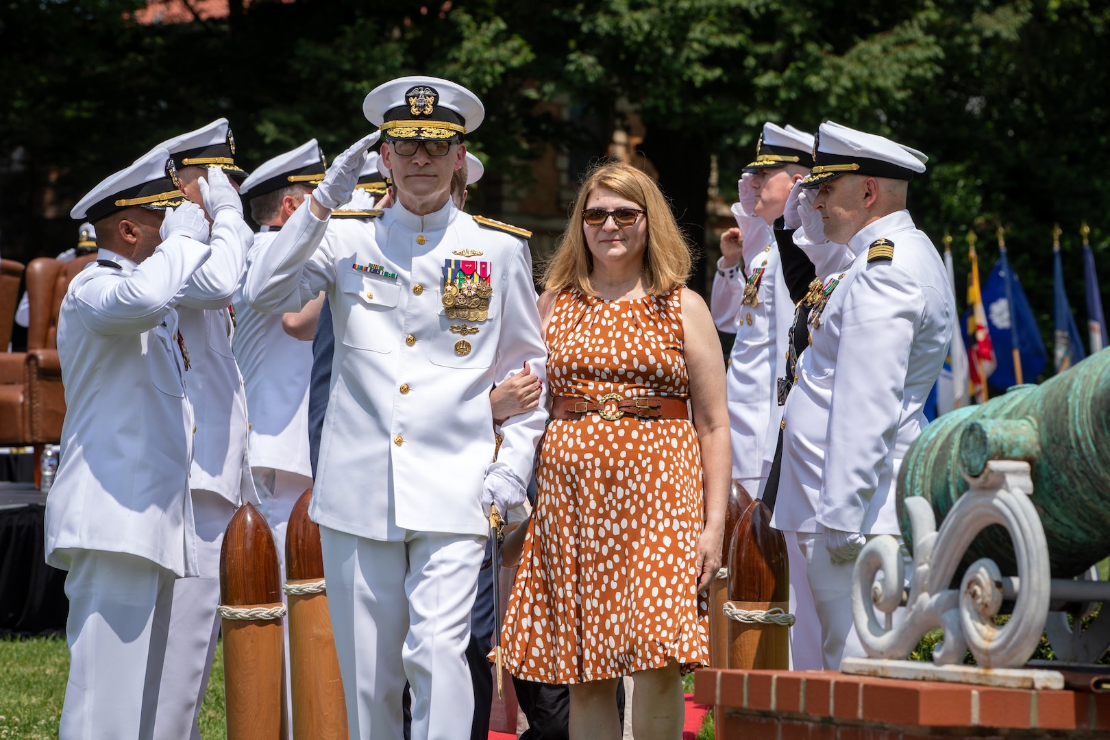 Rear Adm. William Greene salutes sideboys alongside his wife during his retirement ceremony held at the Washington Navy Yard’s Leutze Park, June 6. Greene retired after nearly 37 years of distinguished service.