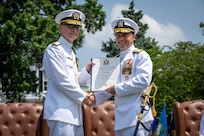 Admiral Jim Kilby, acting Chief of Naval Operations (right) presents Rear Adm. William Greene with a certificate of retirement during a retirement and change of office ceremony held at the Washington Navy Yard’s Leutze Park, June 6. Rear Admiral Andrew Biehn relieved Greene as Director of Surface Ship Maintenance, Modernization, and Sustainment (SEA 21). (U.S. Navy photo by Laura Lakeway)