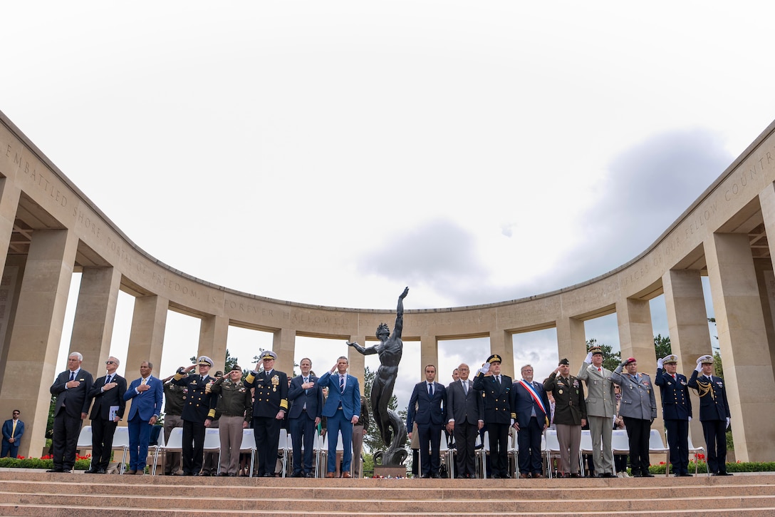 A group of leaders stand on the top of stairs outside.