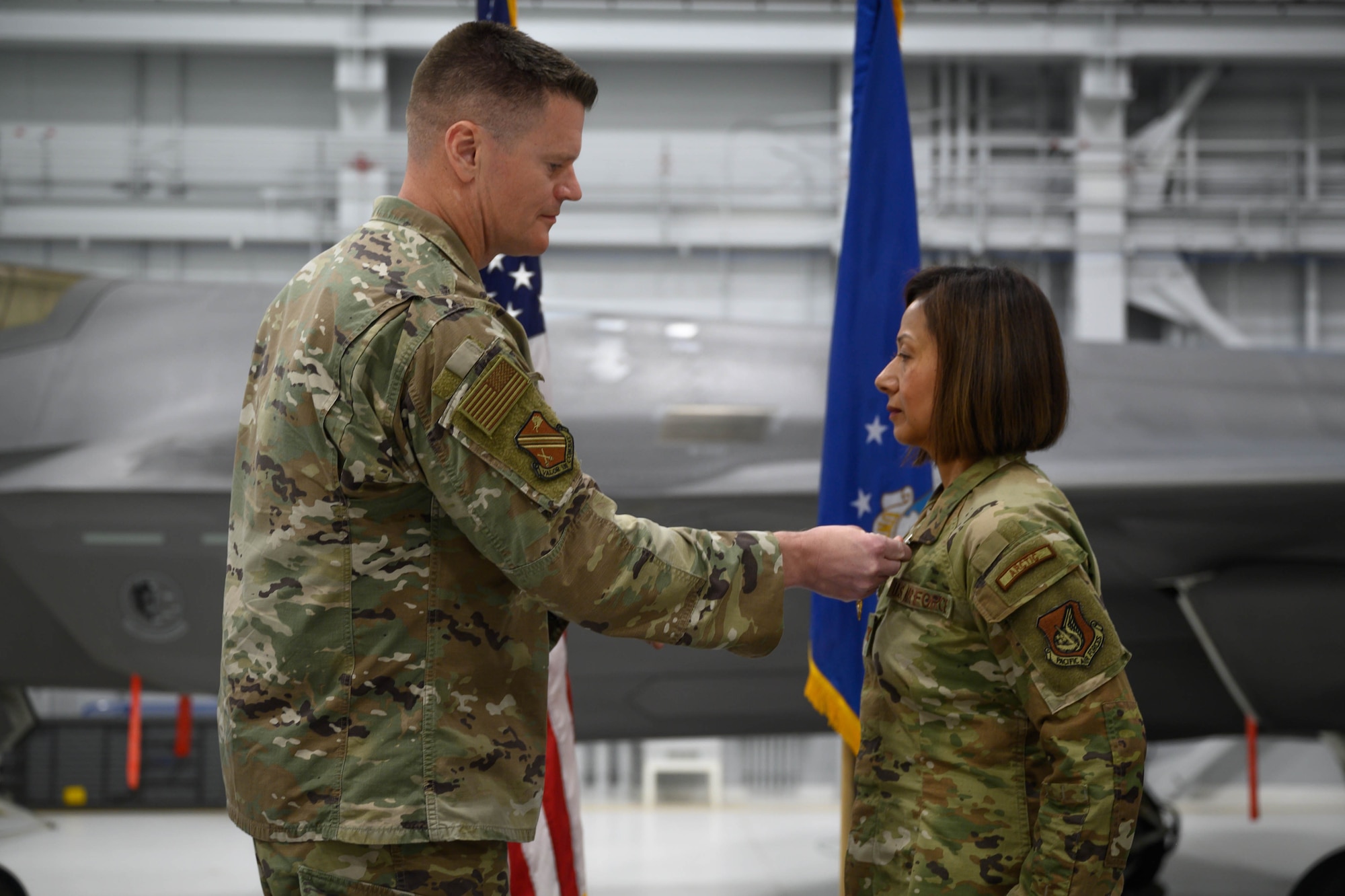 U.S. Air Force Col. Paul Townsend, 354th Fighter Wing commander, awards Col. Fara Buss, 354th Medical Group outgoing commander, with the Meritorious Service Medal during a change of command ceremony at Eielson Air Force Base, Alaska, June 6, 2025.