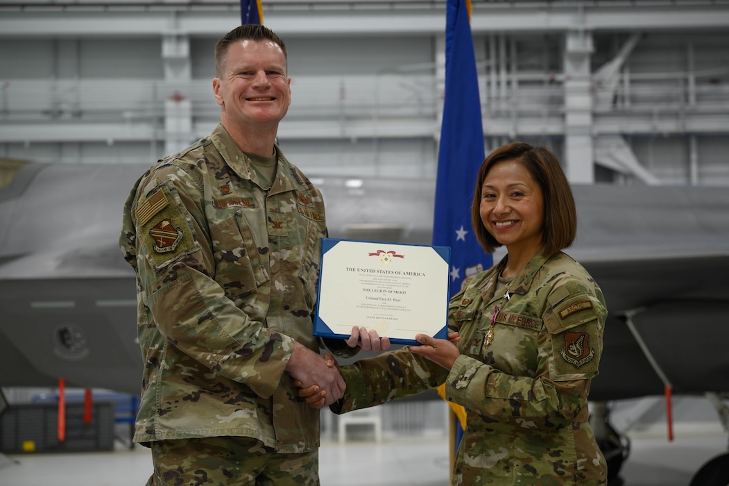 U.S. Air Force Col. Paul Townsend, 354th Fighter Wing commander, awards Col. Fara Buss, 354th Medical Group outgoing commander, with the Meritorious Service Medal during a change of command ceremony at Eielson Air Force Base, Alaska, June 6, 2025.