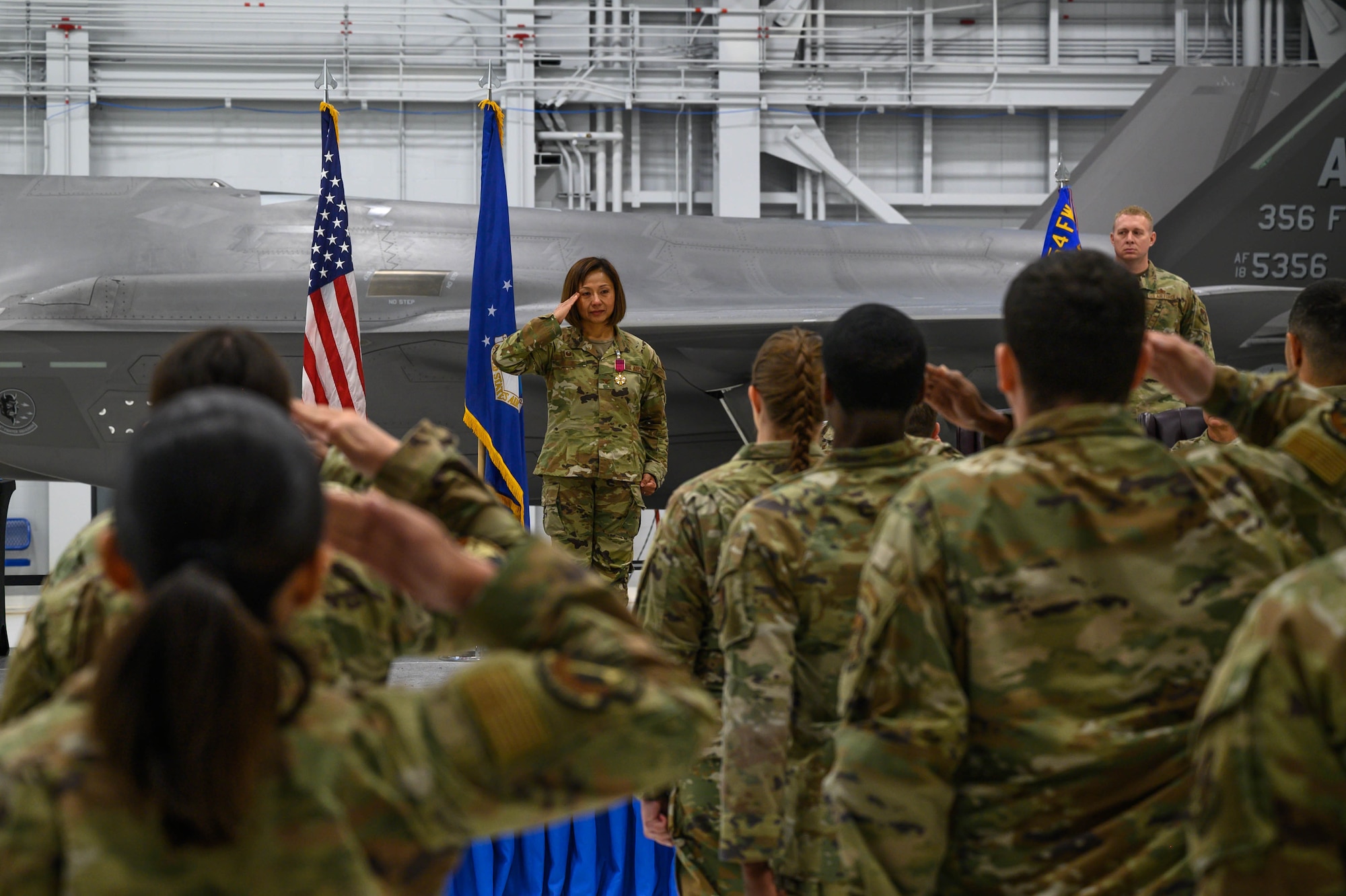 U.S. Air Force Col. Fara Buss, 354th Medical Group outgoing commander, renders a final salute to the flight during the group change of command at Eielson Air Force Base, Alaska, June 6, 2025.