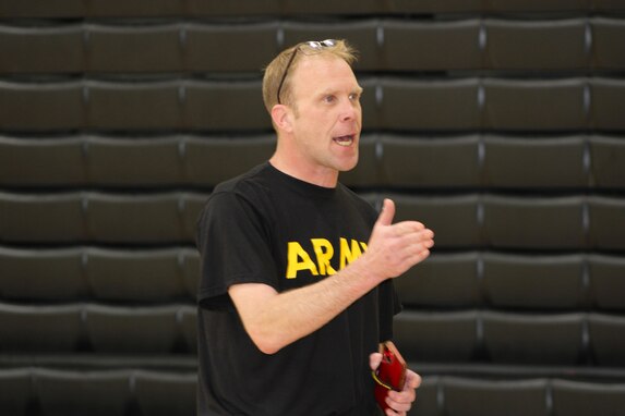 SSG Holliday speaks to students during a Fitness Challenge event at a local high school, May 2025. The event aimed to promote teamwork, physical fitness, and interest in Army career opportunities.