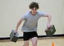 A high school student powers through the ammo can relay during a U.S. Army Fitness Challenge event in the Kansas City area, May 2025. The event, hosted by the U.S. Army Recruiting Battalion Kansas City, encouraged physical fitness and team-building through hands-on activities.