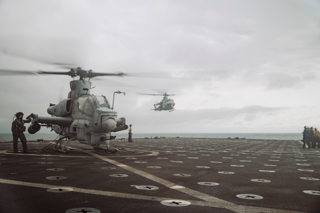 A U.S. Marine Corps AH-1Z Viper, left, attached to Marine Light Attack Helicopter Squadron 369, Marine Aircraft Group 39, 3rd Marine Aircraft Wing, refuels on the flight deck of the amphibious dock landing ship USS Harpers Ferry (LSD 49) during Quarterly Underway Amphibious Readiness Training 25.3 while underway in the Pacific Ocean, June 3, 2025.