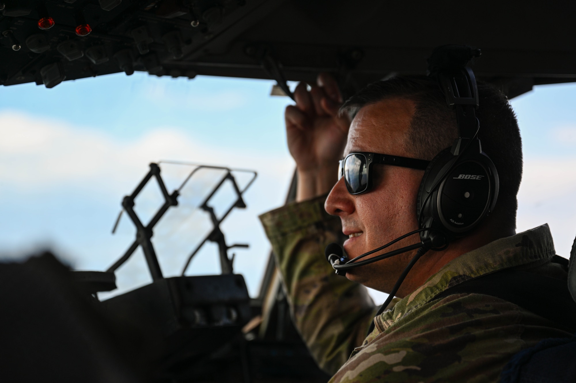 U.S. Air Force Capt. Andrew Miller-Bissell, 58th Airlift Squadron chief of command and control operations, scans the horizon over Nevada, May 28, 2025. The Joint Forcible Entry training focused on combining mobility, fighter, and other joint aircraft and forces to enter enemy airspace and take control of a key location. (U.S. Air Force photo by Airman 1st Class Jonah Bliss)