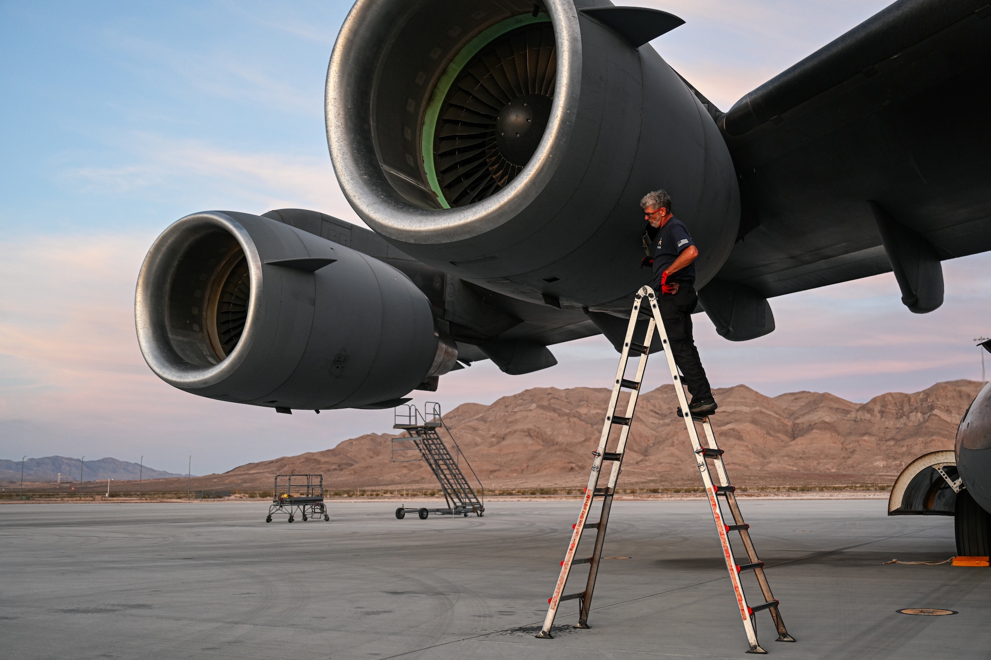 James Daugherty, 97th Aircraft Maintenance Squadron C-17 dedicated crew chief, inspects the engine of a C-17 Globemaster III aircraft at Nellis Air Force Base, Nevada, May 28, 2025. The inspection was part of standard post-flight maintenance procedures. (U.S. Air Force photo by Airman 1st Class Jonah Bliss)