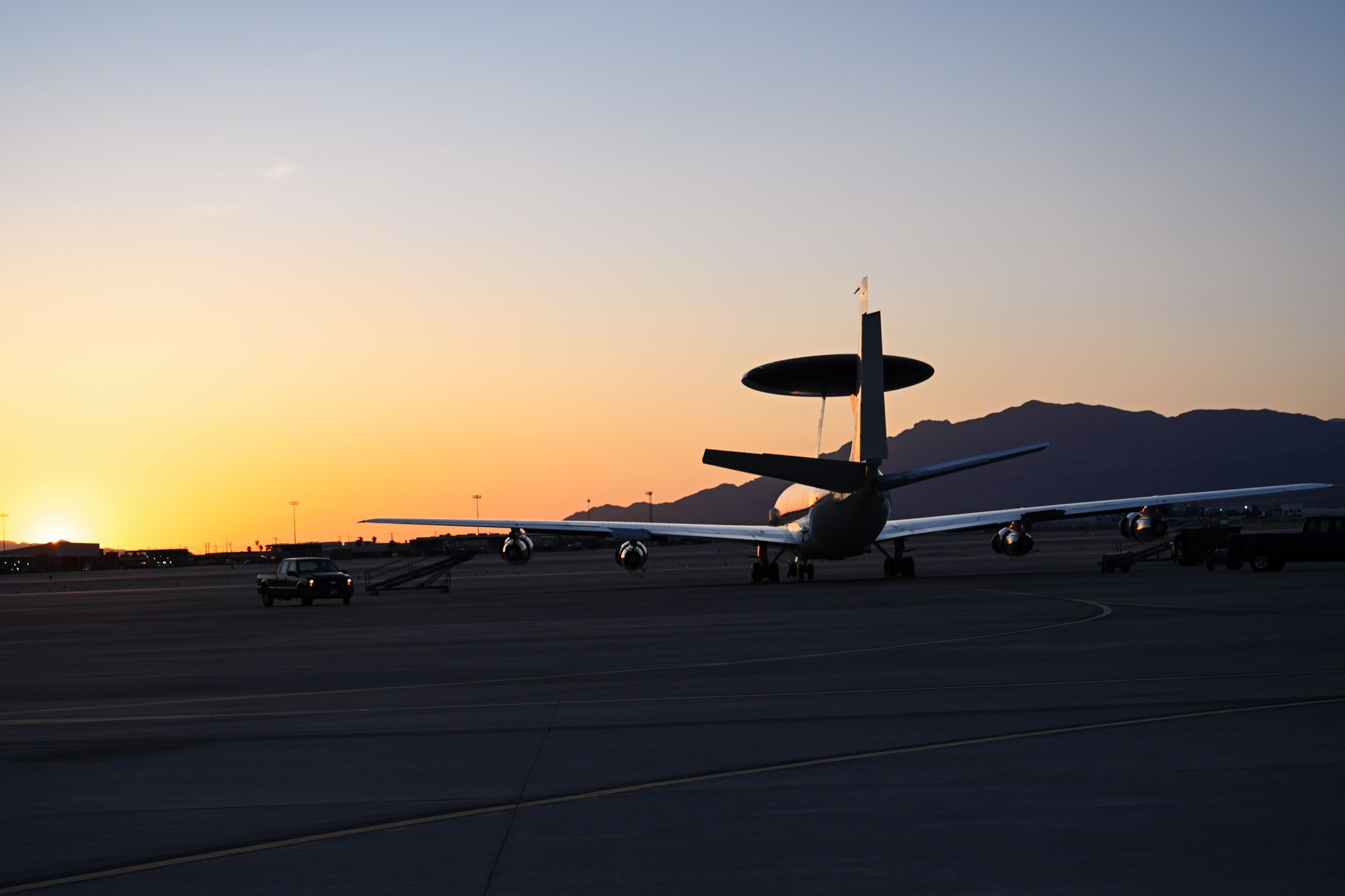 A U.S. Air Force E-3 Sentry aircraft assigned to the 552nd Air Control Wing, is parked on the flightline during sunset at Nellis Air Force Base, Nevada, May 28, 2025. The E-3 Sentry is an airborne warning and control system aircraft that provides command and control, surveillance, and tracking to help detect and manage targets during operations. (U.S. Air Force photo by Airman 1st Class Jonah Bliss)