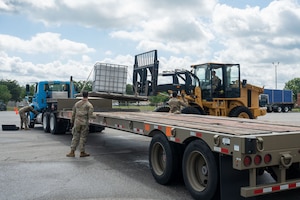 Airmen unload heavy equipment from a tractor trailer at Robins Air Force Base, Georgia, May 13, 2025.