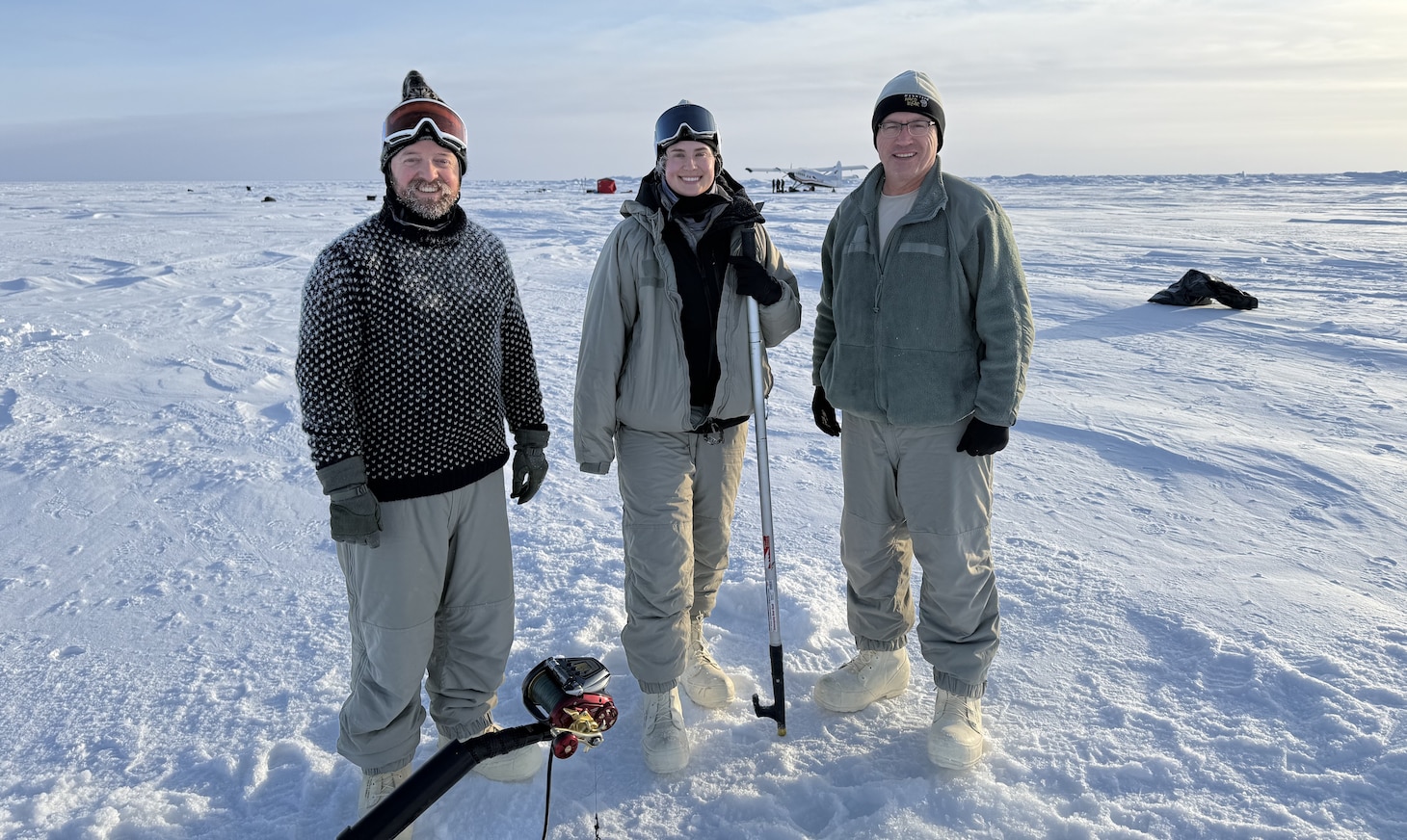 In February 2025, Arctic researchers William Jenkins, U.S. Navy Lt. Caroline Kelly, and Benjamin Reeder (left to right) conducted cryoacoustics experiments on sea ice floating in the Arctic Ocean to improve current and future U.S. naval operations in this growingly contested environment. (Courtesy photo from Mike Demello, Arctic Submarine Laboratory)