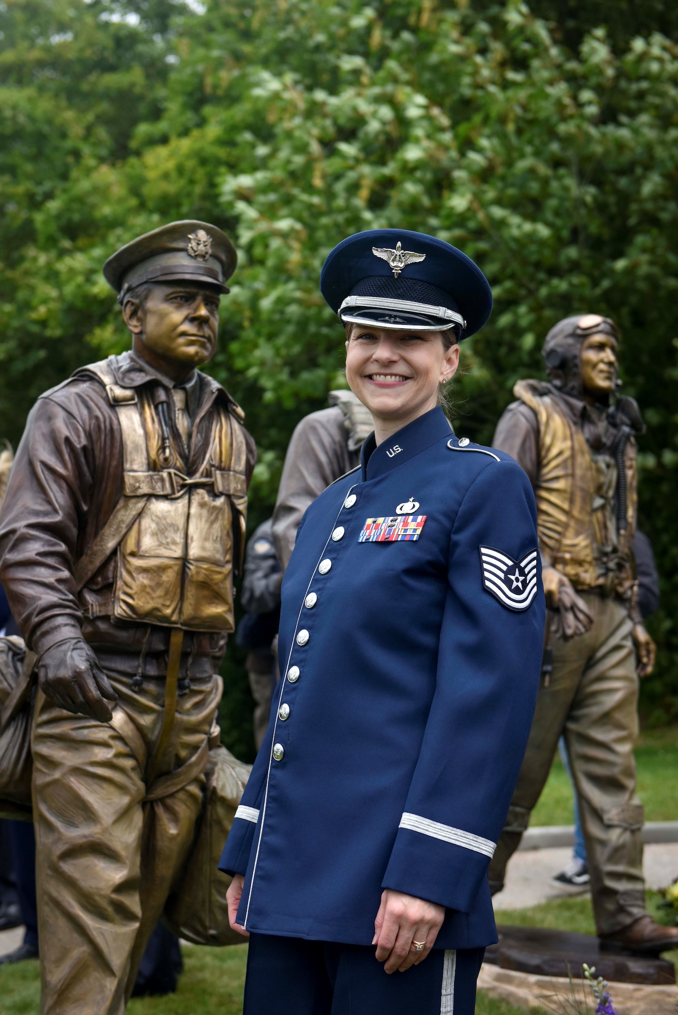 U.S. Air Force Tech Sgt. Michelle Doolittle assigned to U.S. Air Forces in Europe Band poses at Sainte-Mère-Église, Normandy, France, June 5, 2025, in front of the statue of her relative, Gen. James “Jimmy” Doolittle, former 8th Air Force commander and pilot who led the Doolittle Raid against Japan in 1942. Doolittle carries on her family’s legacy as a vocalist, using music to strengthen U.S. Air Force international ties and commemorate shared history with Allies and partners.