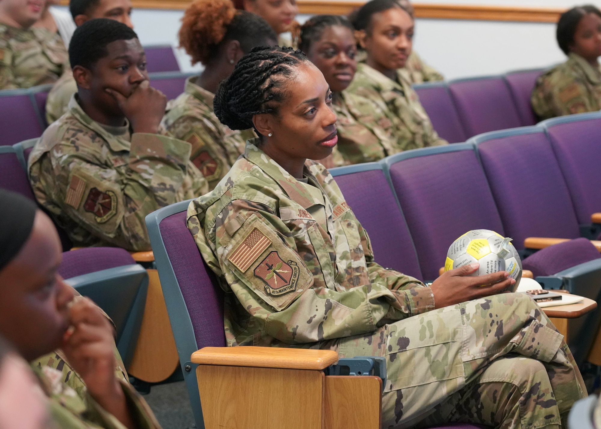 Airmen sitting in auditorium during commander support staff conference.