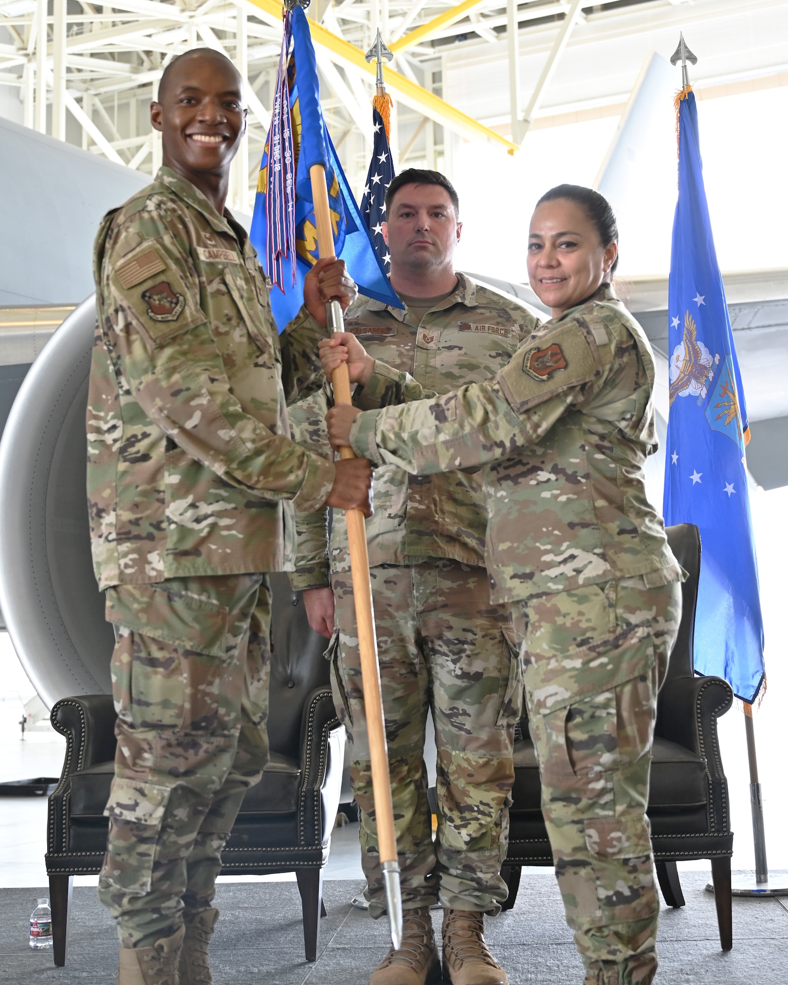 (Left to right) Col. Jermaine Campbell, 931st Maintenance Group commander takes the guidon from Maj. Anabel Allen, outgoing 931st Maintenance Squadron commander.