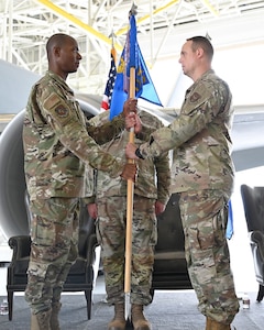 (Left to right) Col. Jermaine Campbell, 931st Maintenance Group commander hands the guidon to Maj. Burl "Trey" Butler, incoming 931st Maintenance