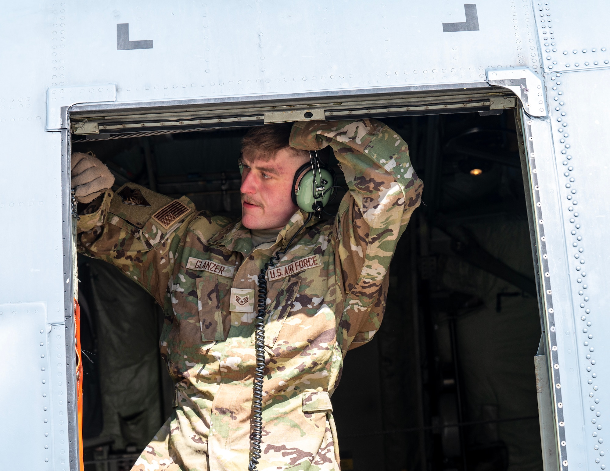 U.S. Air Force Staff Sgt. Jack Glanzer, 109th Airlift Squadron, shuts the door of a C-130 Hercules during the Fleet Launch Under Severe Hazards (Flush) training in St. Paul, Minn., March 1, 2025.