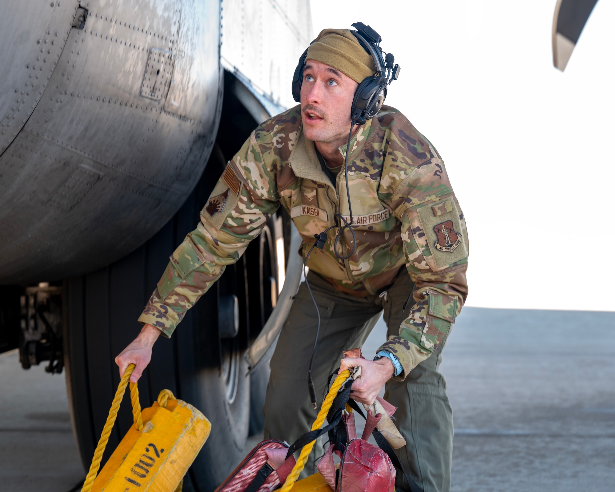 U.S. Air Force Airman 1st Class Joseph Kaiser, 109th Airlift Squadron, removes chalk from a C-130 Hercules as part of the Fleet Launch Under Severe Hazards (Flush) training in St. Paul, Minn., March 1, 2025.