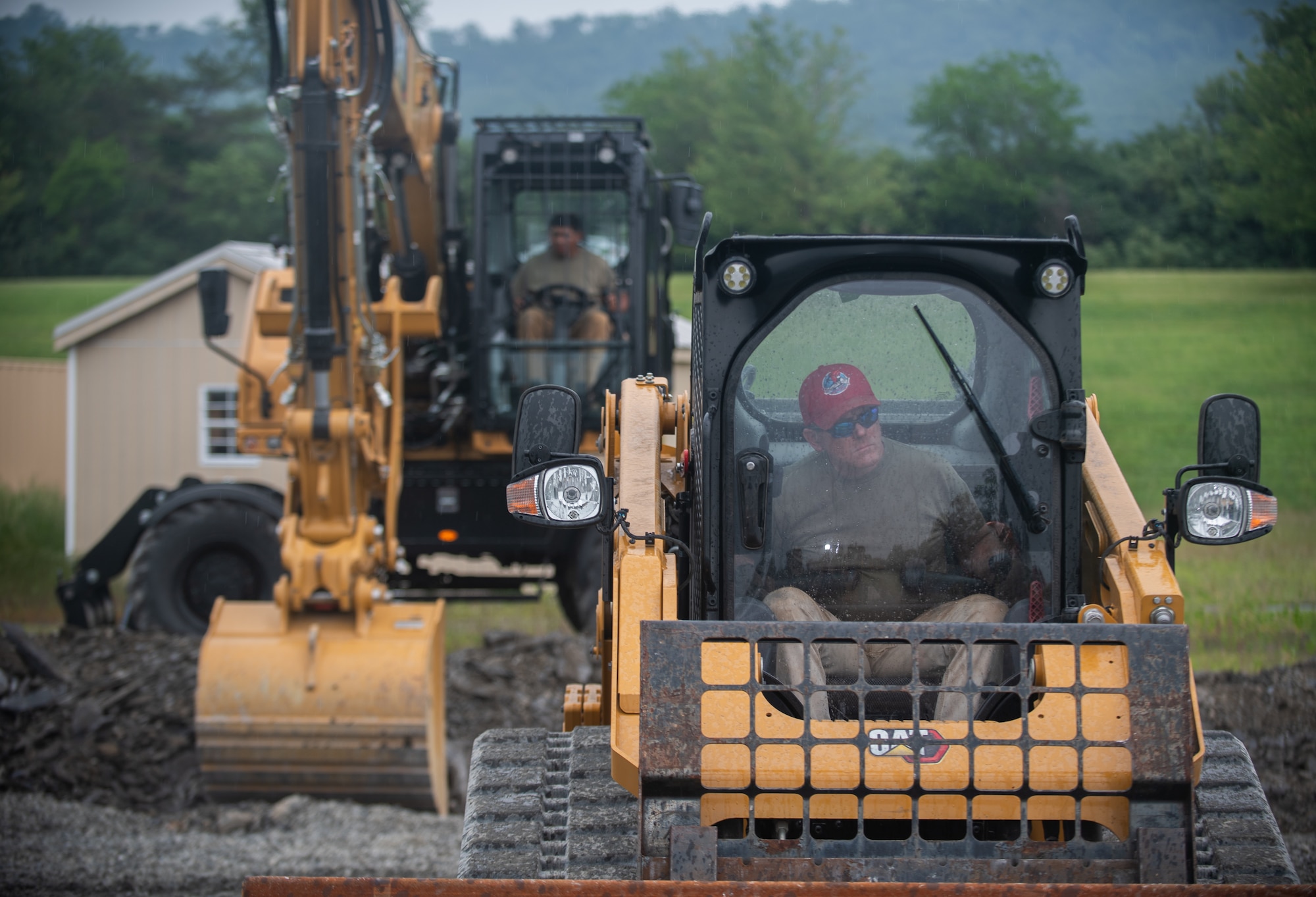 Tech. Sgt. Matthew Brooks (right), structures specialist with the 201st RED HORSE Squadron Detachment 1, constructs a Rapid Airfield Damage Repair system at Fort Indiantown Gap, Pennsylvania, June 6, 2025.