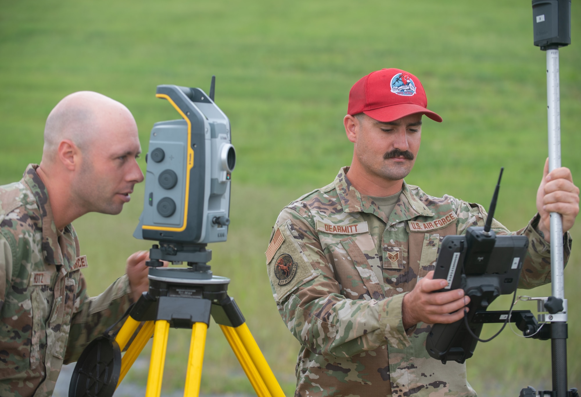 Tech. Sgt. Andrew Huntz (left) and Staff Sgt. Dylan DeArmitt, assigned to the 201st RED HORSE work on surveying the construction of a Rapid Airfield Damage Repair system at Fort Indiantown Gap, Pennsylvania, June 7, 2025.