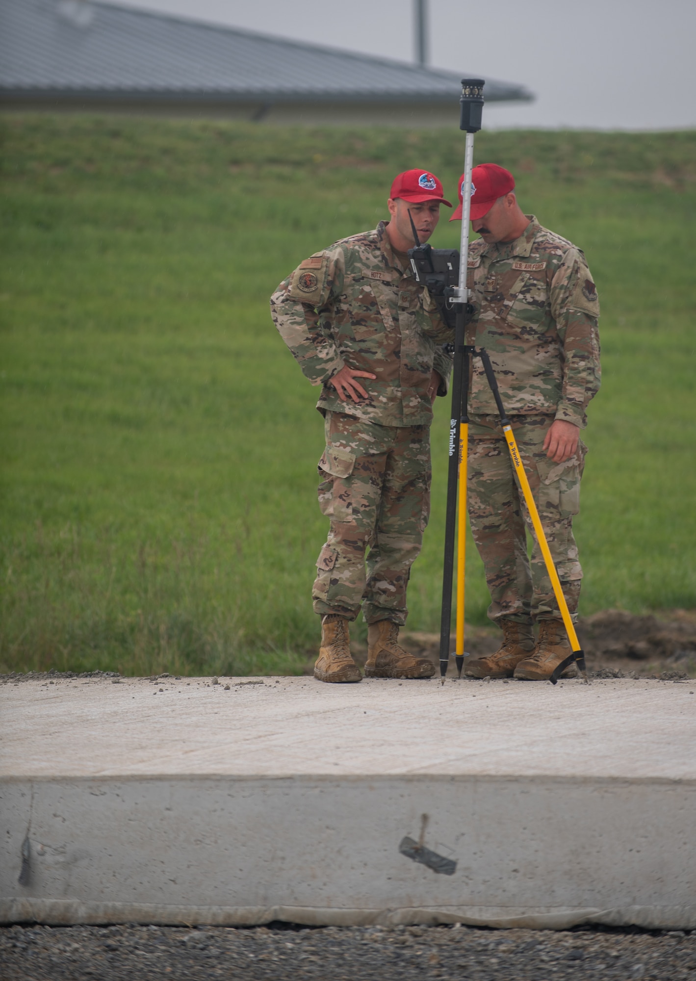 Tech. Sgt. Andrew Huntz (left) and Staff Sgt. Dylan DeArmitt, assigned to the 201st RED HORSE work on surveying the construction of a Rapid Airfield Damage Repair system at Fort Indiantown Gap, Pennsylvania, June 7, 2025.