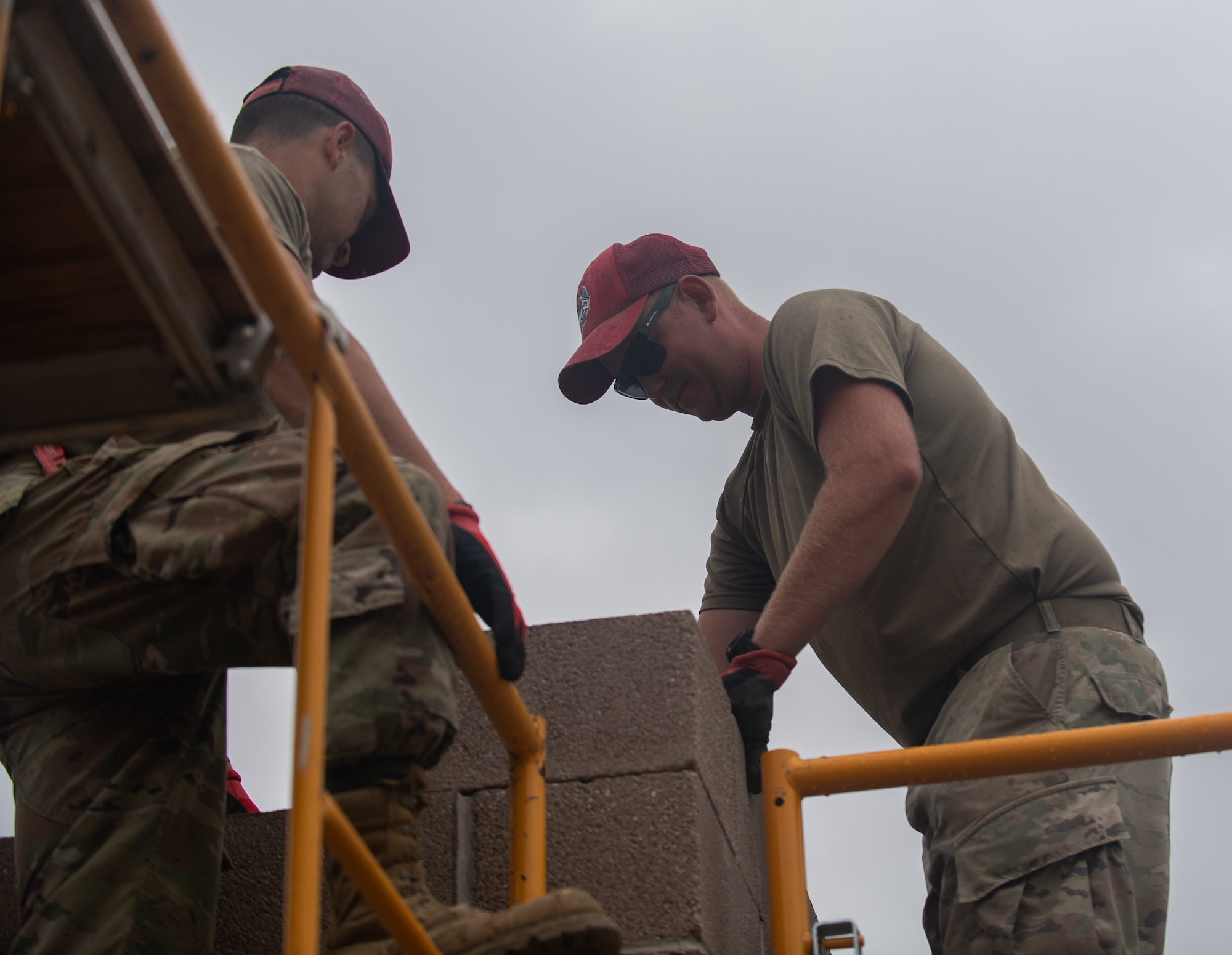 Staff Sgt. Ian Fogleman (left) and Staff Sgt. Dakota Morgan, structures specialists assigned to the 201st RED HORSE Squadron, construct a new range tower at Fort Indiantown Gap, Pennsylvania, June 6, 2025.