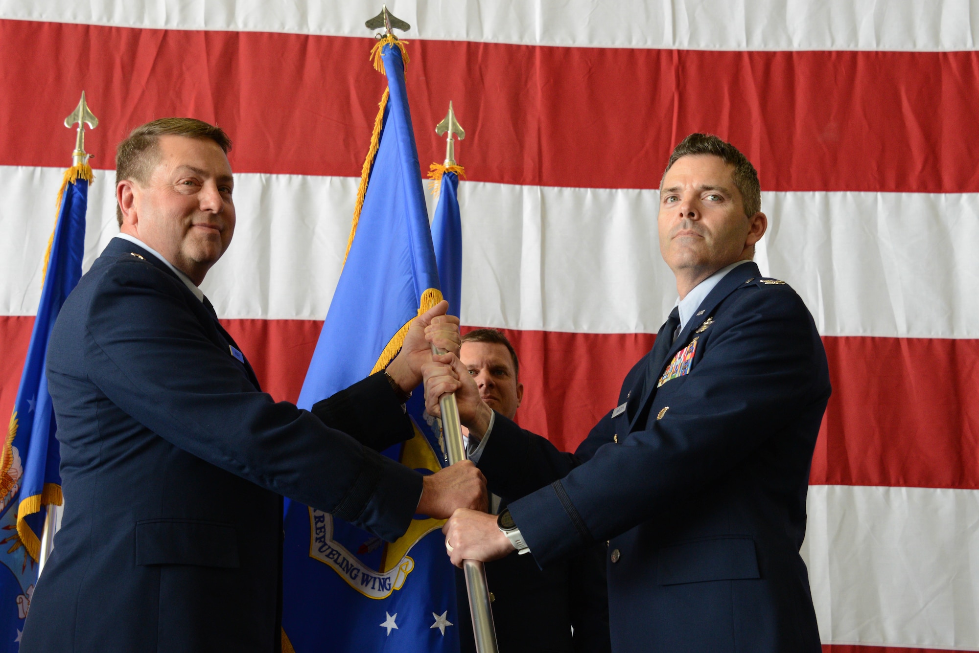 .S. Air National Guard Col. Adam Carlson, incoming 185th Air Refueling Wing Commander, right, assumes command of the 185th ARW by accepting the unit’s guidon from Brig. Gen. Mark Muckey, Deputy Adjutant General for the Iowa Air National Guard, left,