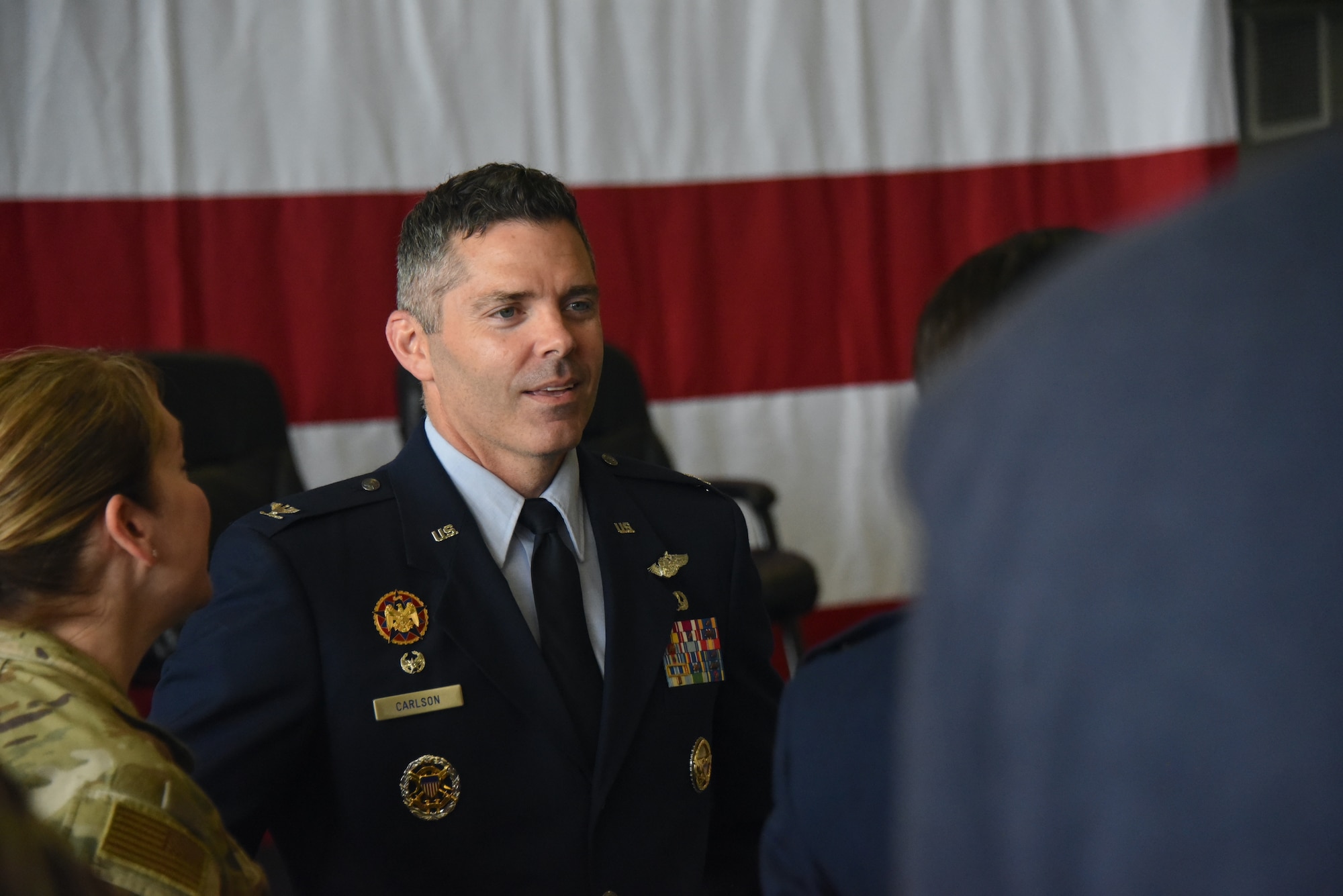 Col. Adam Carlson greets service members