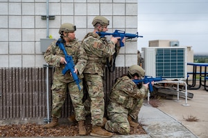 Staff Sgt. Graciela Gomez, Tech Sgt. Patrick Alderson, and Staff Sgt Rachel McKinney perform a sweep outside a building during a simulated active shooter scenario during an exercise at Hill Air Force Base, Utah, May 6, 2025.
