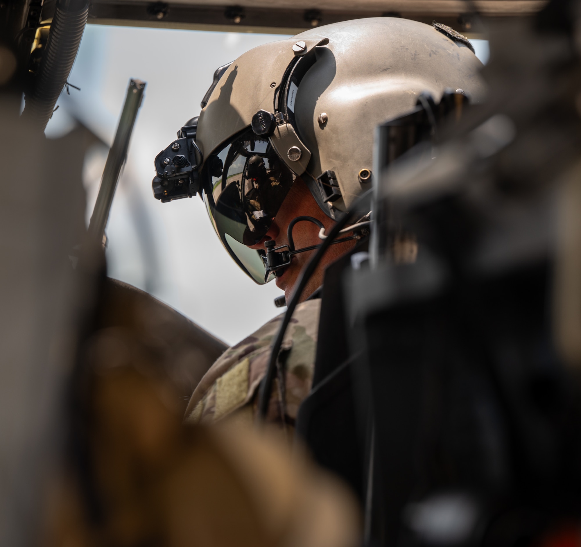 A U.S. Air Force Airman pilots an HH-60W Jolly Green II.
