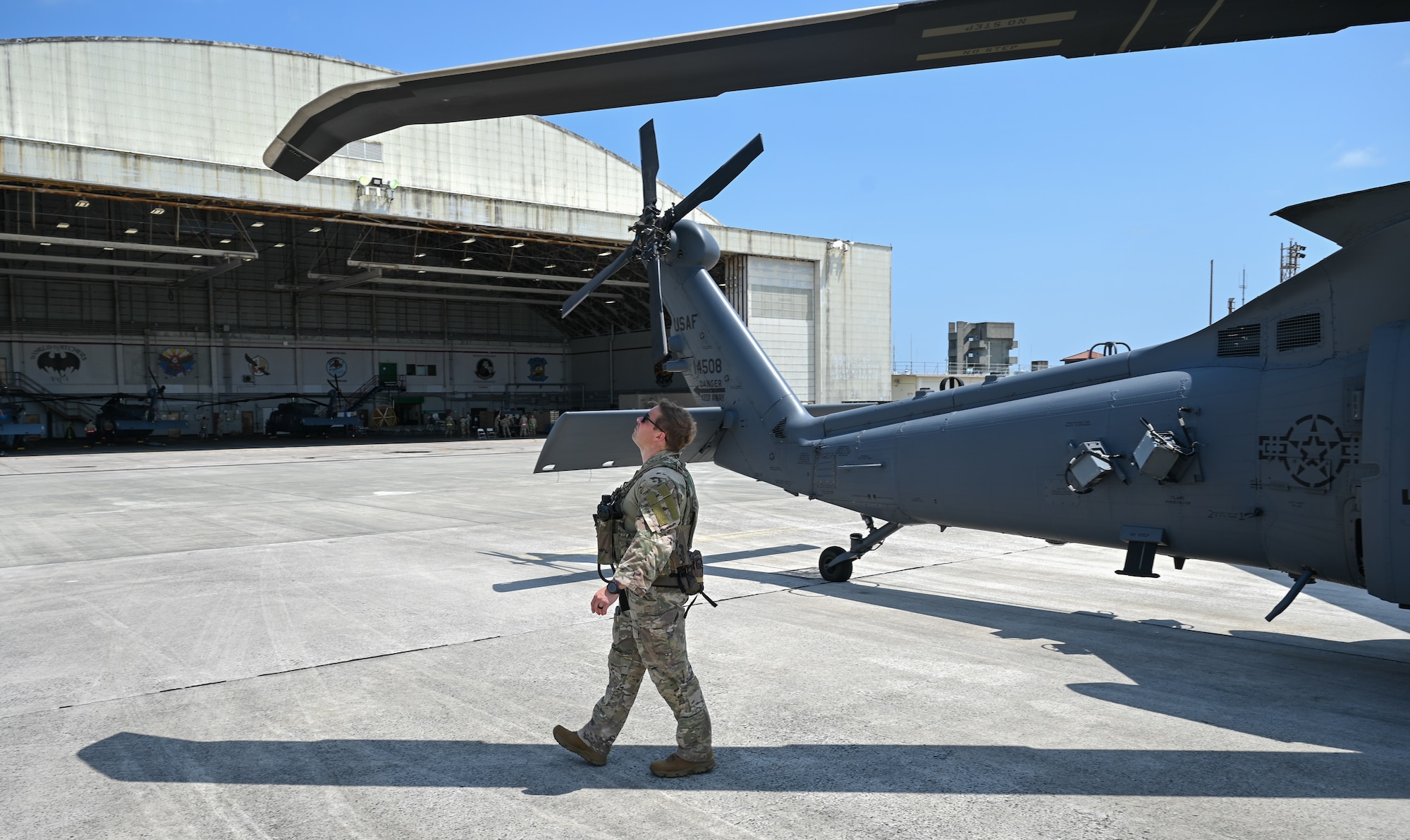 A U.S. Air Force servicemember performs pre-flight checks on an aircraft.