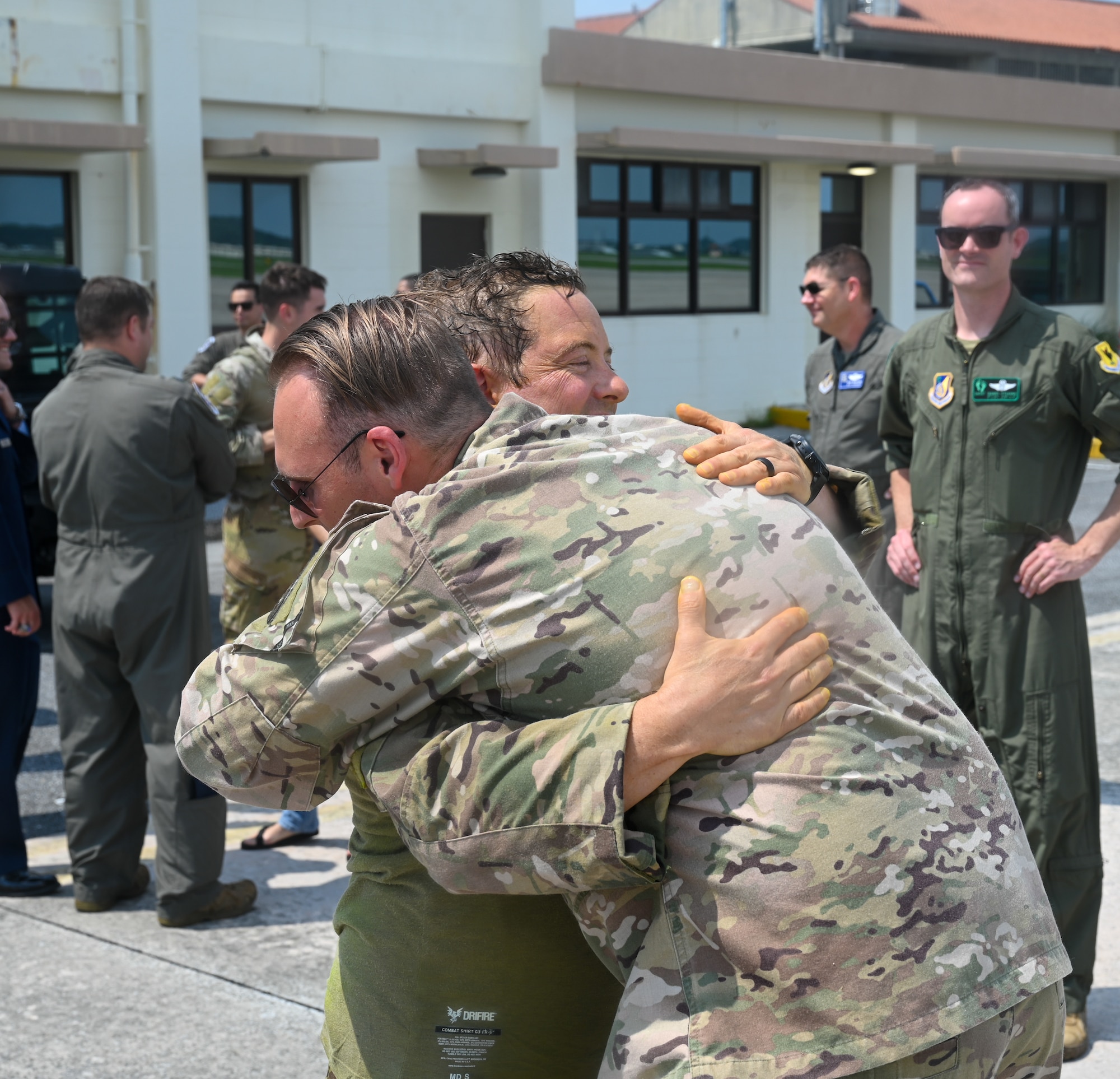Two U.S. Air Force servicemembers hug each other.