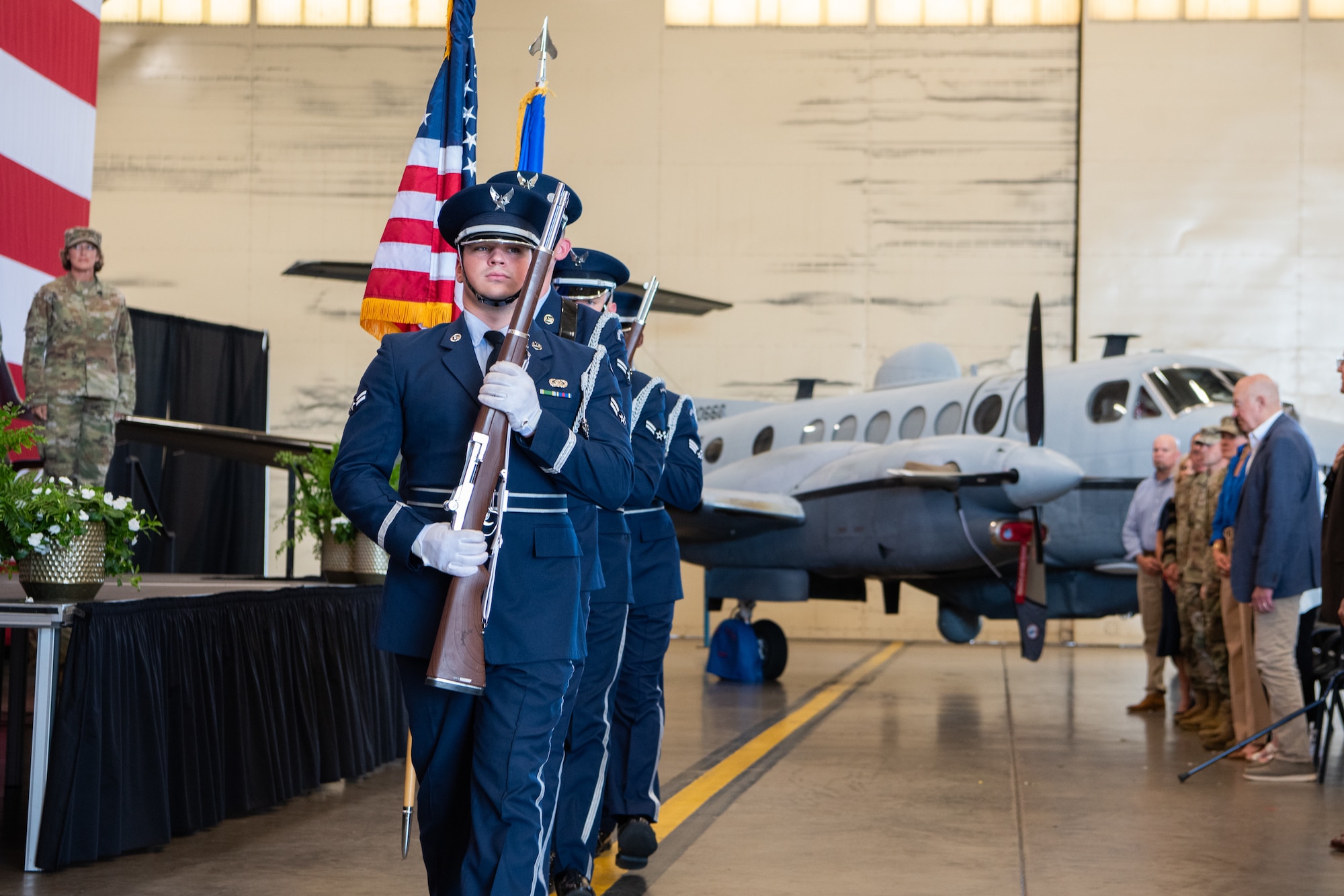 an uniformed color guard performs at a ceremony