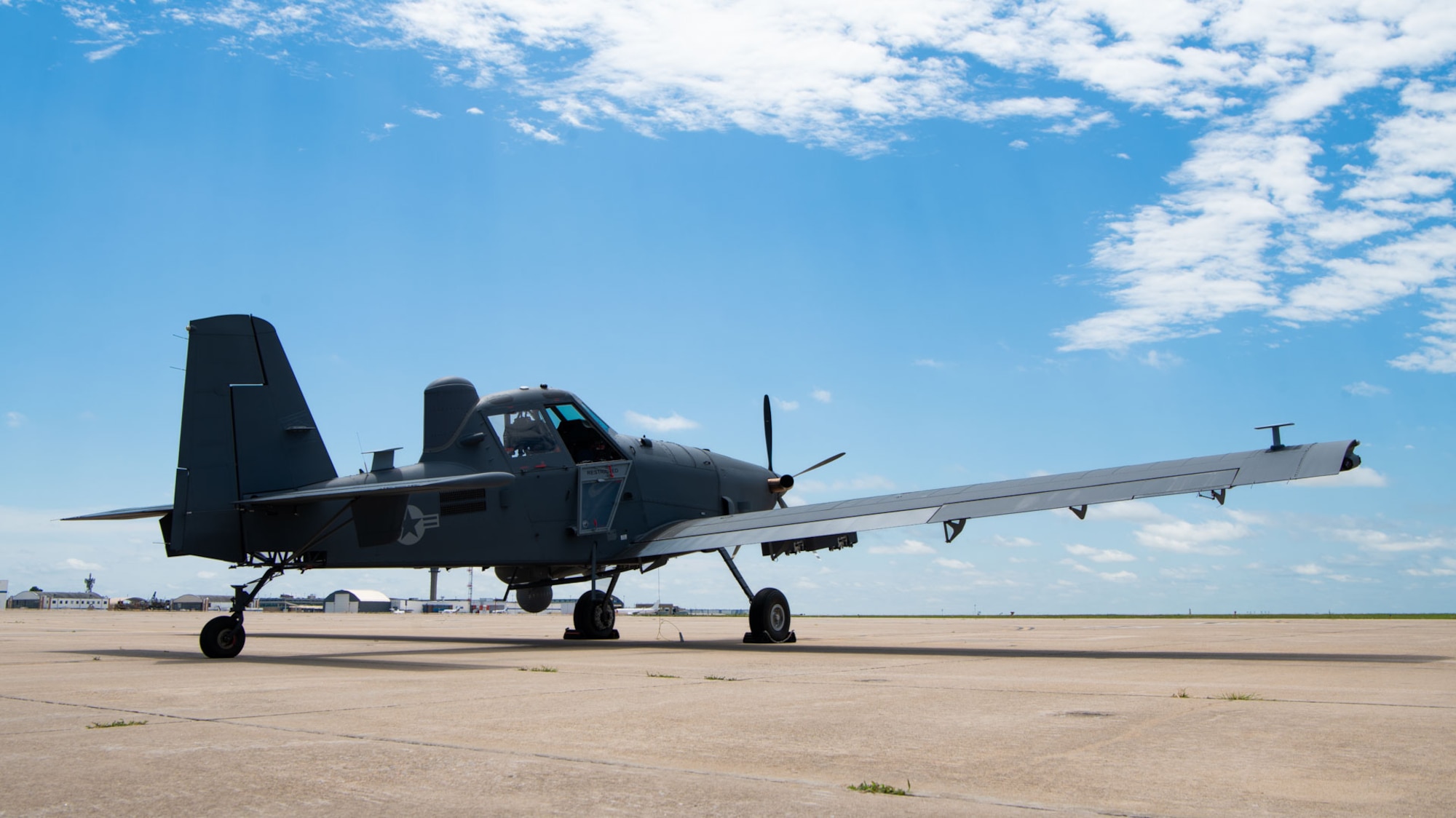 an aircraft sits on a flightline