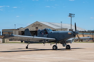 an aircraft sits on a flightline