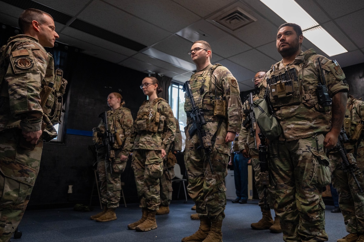 U.S. Air Force 35th Security Forces Squadron patrolmen stand at attention prior to shift change-over at Misawa Air Base, Japan, June 5, 2025