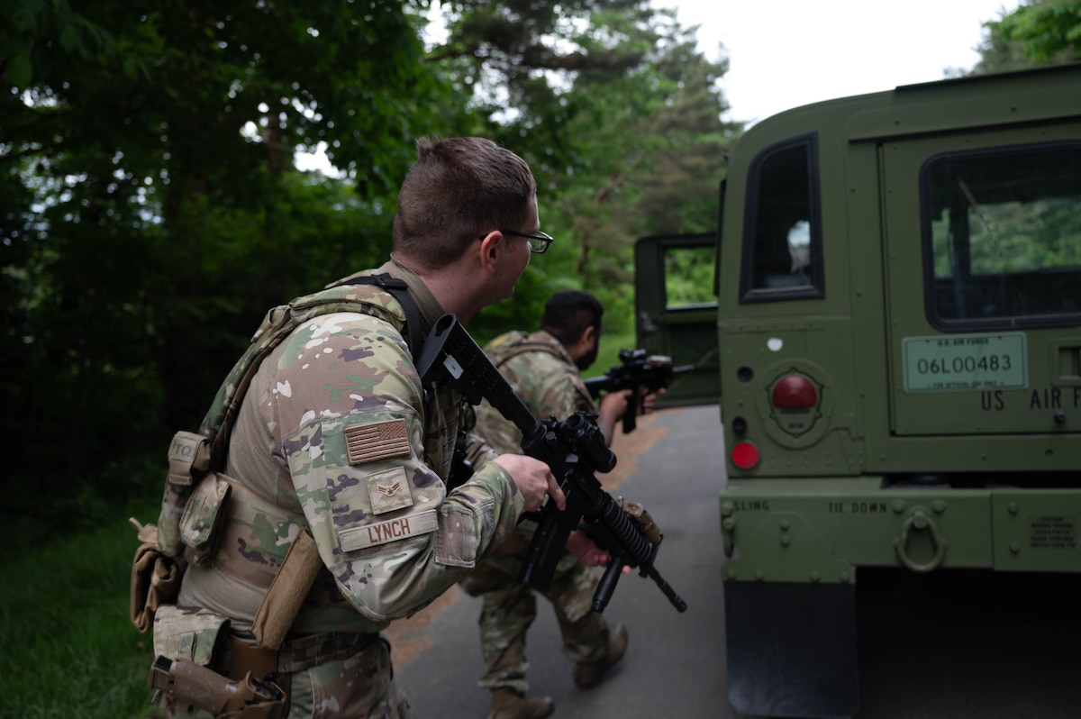 U.S. Air Force Airman 1st Class David Lynch, left, and Senior Airman Alexander Garcia, right, 35th Security Forces Squadron patrolmen, conduct vehicle clearing procedures during a mid-patrol training exercise at Misawa Air Base, Japan, June 5, 2025.