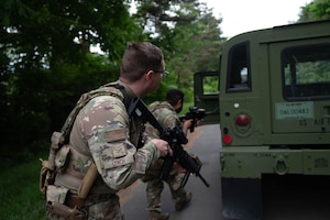 U.S. Air Force Airman 1st Class David Lynch, left, and Senior Airman Alexander Garcia, right, 35th Security Forces Squadron patrolmen, conduct vehicle clearing procedures during a mid-patrol training exercise at Misawa Air Base, Japan, June 5, 2025.