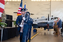 an uniformed color guard performs at a ceremony