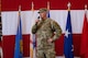 a man in uniform talks with a microphone in hand