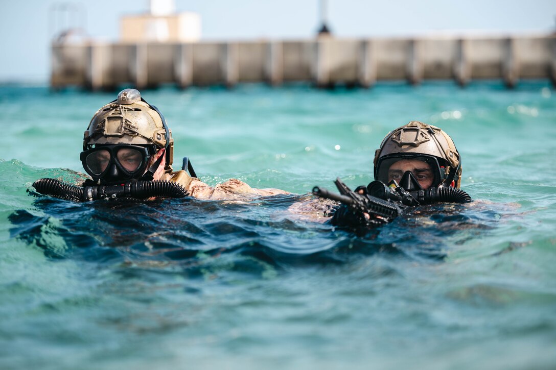 U.S. Marine Corps Sgt. Jacob Miller, a reconnaissance Marine with Charlie Company, 2d Reconnaissance Battalion, 2d Marine Division, holds a security position while conducting infiltration and exfiltration procedures during Exercise Caribbean Coastal Warrior 25 in Savaneta, Aruba, May 24, 2025. Exercise CCW 25 is a bilateral training exercise with Dutch forces and 2d Reconnaissance Battalion aimed to expand knowledge and proficiency when operating in littoral and coastal regions. (U.S. Marine Corps photo by Lance Cpl. Hunter J. Kuester)