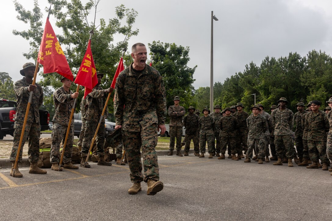 U.S. Navy Lt. David Miloscia, a chaplain with Headquarters and Service Battalion, 2nd Marine Logistics Group, addresses the battalion after a 10km forced march on Marine Corps Base Camp Lejeune, North Carolina, June 6, 2025. Miloscia spoke to the Marines about spiritual fitness and ability to inspire others. The 10km forced march was conducted to enhance combat endurance and train for more challenging hikes in the future. (U.S. Marine Corps photo by Cpl. Apollo Wilson)