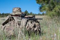 A Security Forces Airman responds to a simulated attack during a field training exercise at Ft. William Henry Harrison, Helena, Mont., June 2, 2025. Security Forces Squadrons from Arizona and Pennsylvania traveled to the Fort for a week of field training. The field instruction consisted of patrol movements, base security, key leader engagements, chemical, biological, radiological, nuclear and explosives detection response, and simulated attacks from opposition forces. (U.S. Air National Guard photo by Master Sgt. Michael Matkin)