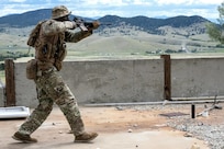 A Security Forces Airman clears an area during a field training exercise at Ft. William Henry Harrison, Helena, Mont., June 4, 2025. Security Forces Squadrons from Arizona and Pennsylvania traveled to the Fort for a week of field training. The field instruction consisted of patrol movements, base security, key leader engagements, chemical, biological, radiological, nuclear and explosives detection response, and simulated attacks from opposition forces. (U.S. Air National Guard photo by Master Sgt. Michael Matkin)
