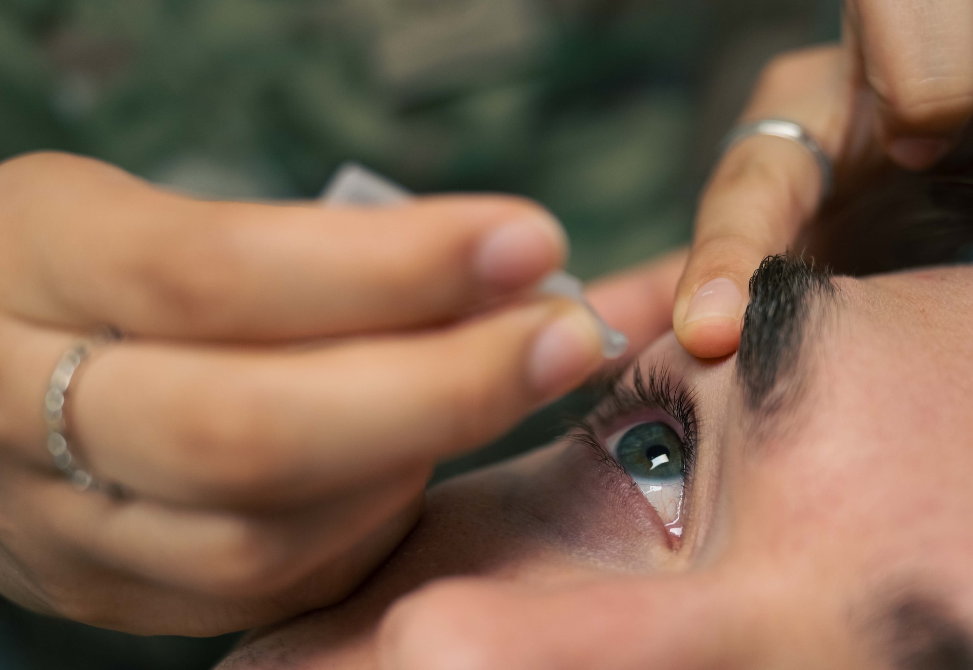 U.S. Air Force Airman 1st Class Sophia Mateus 86th Operational Medical Readiness Squadron, optometry technician, administers eye drops to a patient at Ramstein Air Base, Germany, June 2, 2025. The optometry flight motto ‘sight to shoot’ emphasizes their role in providing eye care to personnel so Airmen can execute the mission. (U.S. Air Force photo by Senior Airman Sabrina Fuller-Judd)