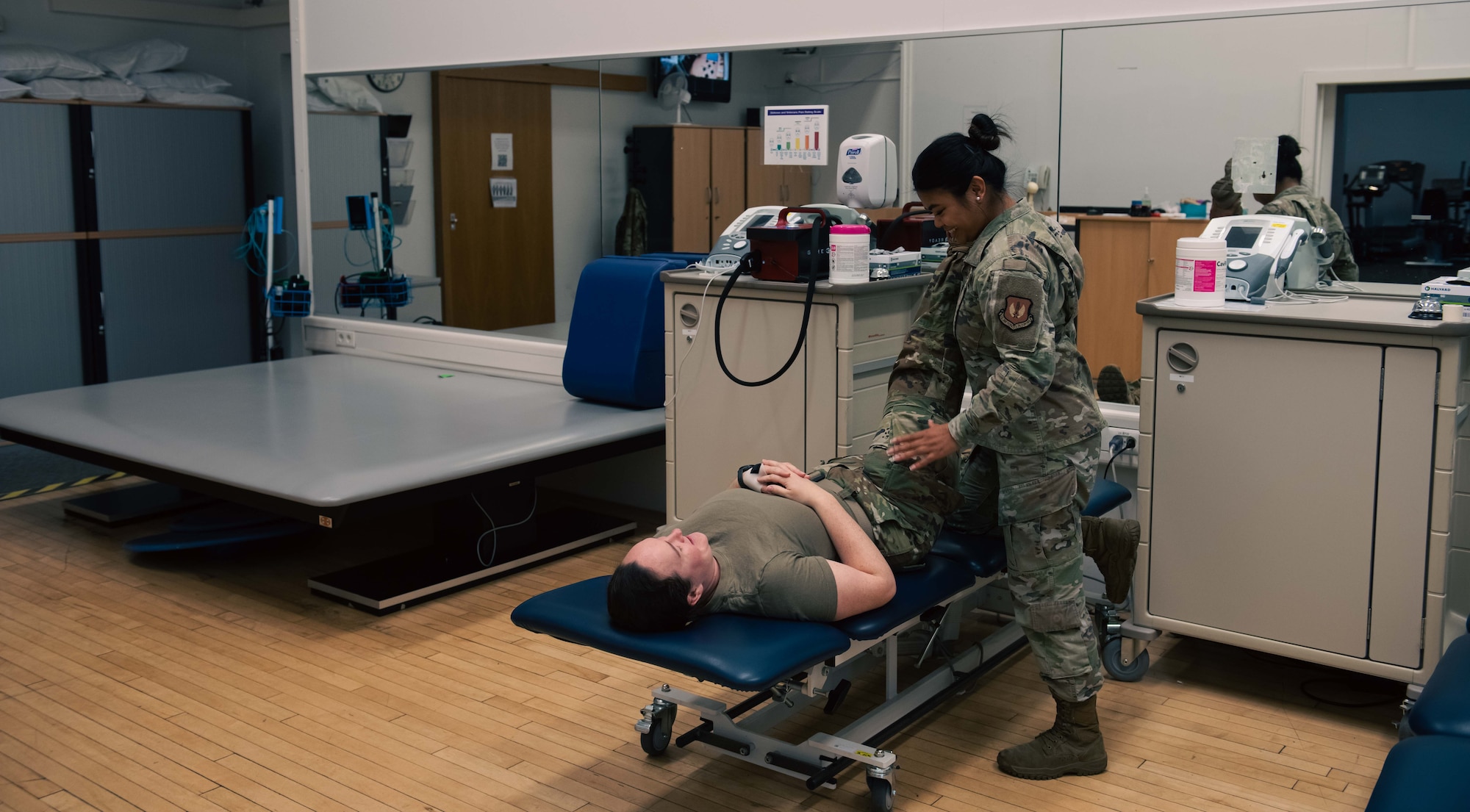 A U.S. Air Force physical therapy technician assigned to the 86th Operational Medical Readiness Squadron, aids a simulated patient at Ramstein Air Base, Germany, June 2, 2025. The 86th OMRS has seven flights to include the physical therapy office, who ensure Airmen maintain peak readiness and operational effectiveness. (U.S. Air Force photo by Senior Airman Sabrina Fuller-Judd)